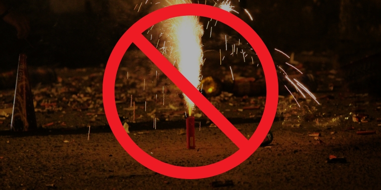 Photo of a firework on the floor with a red prohibited sign on top of the image.