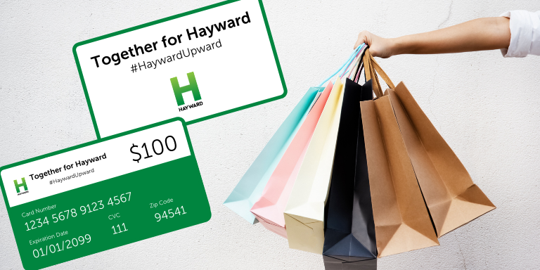 Graphic of a Together for Hayward gift card on top of a photo of a person holding out paper shopping bags.