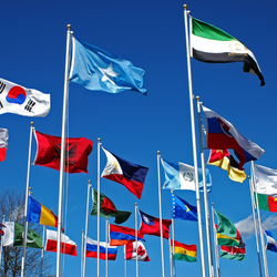Photo of different countries' flags waving in the air.