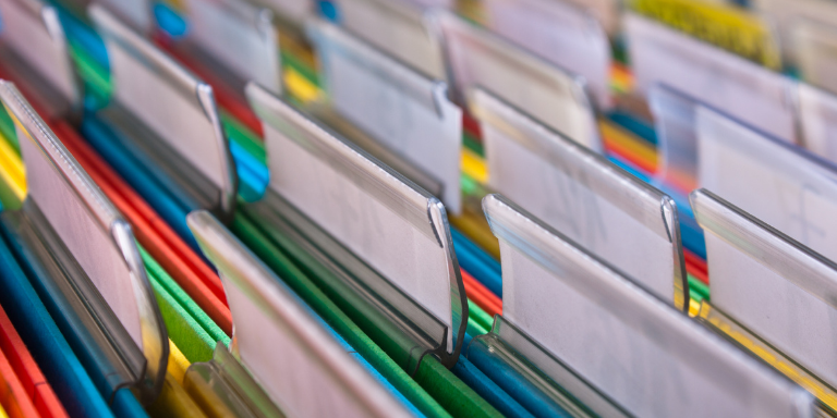 An open file drawer with colorful files
