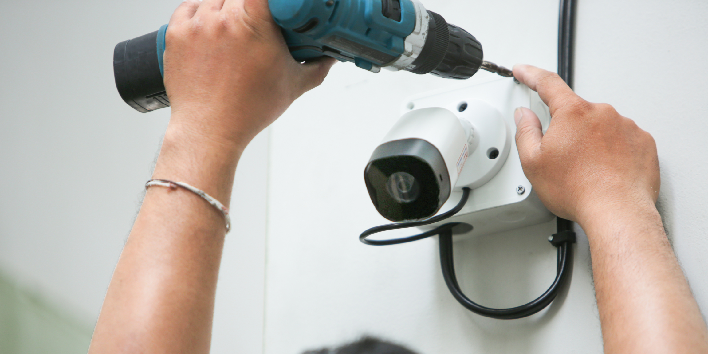 A person installing a security camera