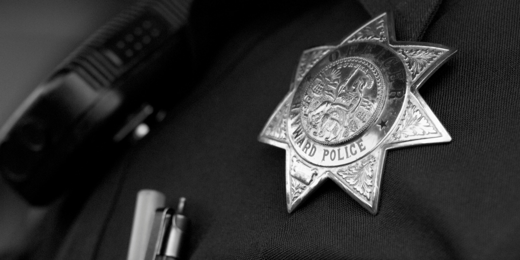 A black and white close up of a police badge