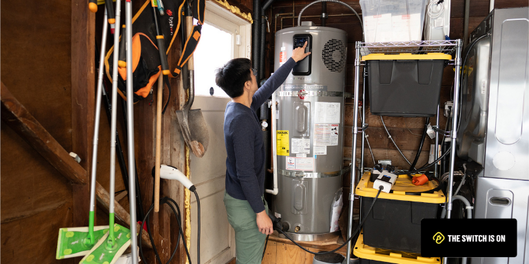 Photo of a person turning on the heat pump in their basement