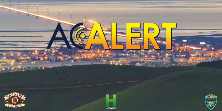Overlooking Hayward from the Stonebrae golf course in the evening. The words AC Alert are over the image. 