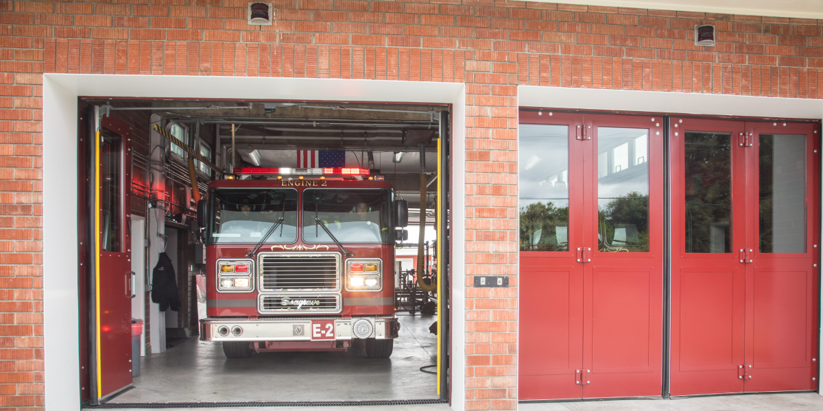 A fire truck exiting a fire station