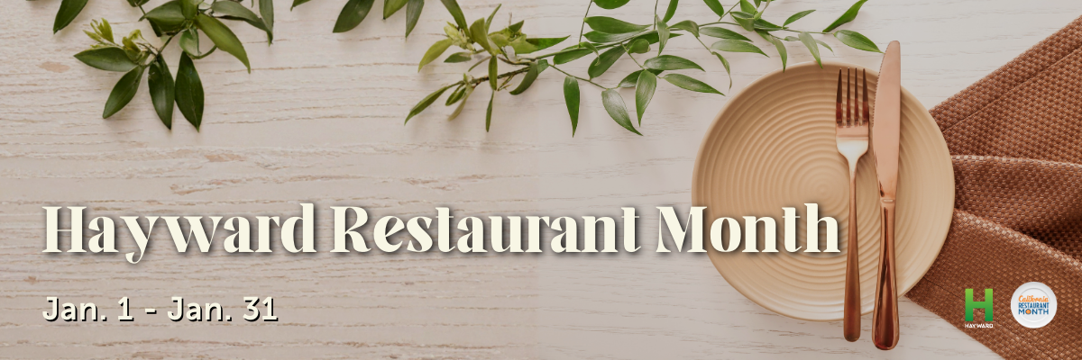 Image of a plate and with utensils on a wooden table. Text on top reads Hayward Restaurant Month Jan. 1-31