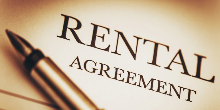 A rental agreement contract and a pen