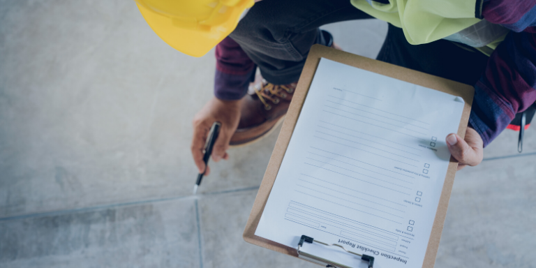 A construction inspector holding a checklist
