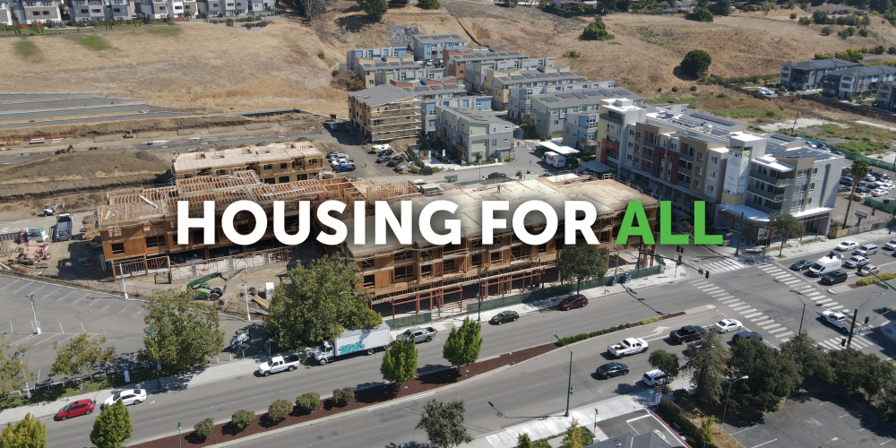 Aerial view of construction area of a new housing project on Mission Blvd. Text overlay reads: Housing for all