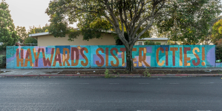 a colorful mural with the words Sisters Cities