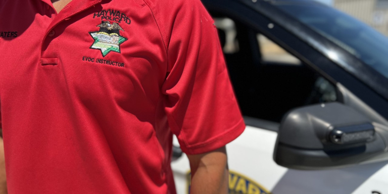 A close up of a red EVOC training shirt and badge