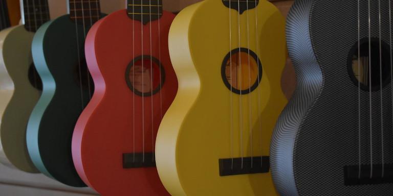A row of multi-colored ukuleles