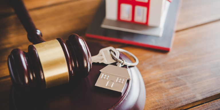 A gavel, lock and image of a house