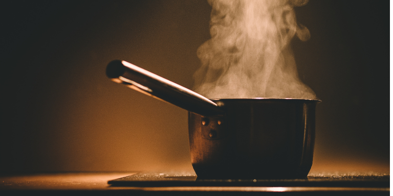 a pot cooking on top of an induction cooktop