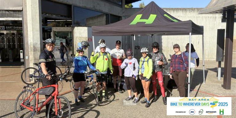 People in bike riding gear stopping at the Hayward charging station on Bike to wherever day 
