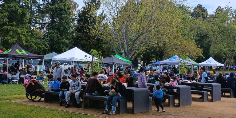 People enjoying lunch after cleaning and greening in Weekes Park