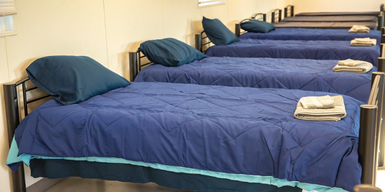 A row of blue beds lined up at the navigation center
