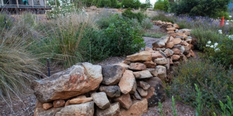 A rock wall is shown as Zone 1: Lean, Clean and Green (5-30 feet) around the yard of home. 