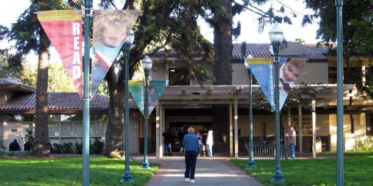 A person walking up to one of the City of Hayward Libraries
