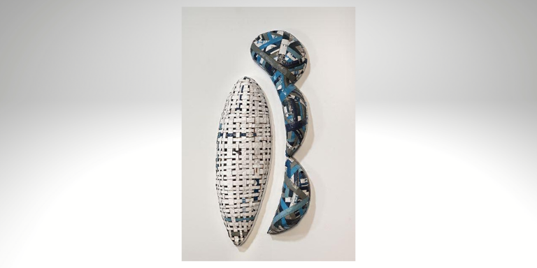 A white and blue sculpture mounted on a wall